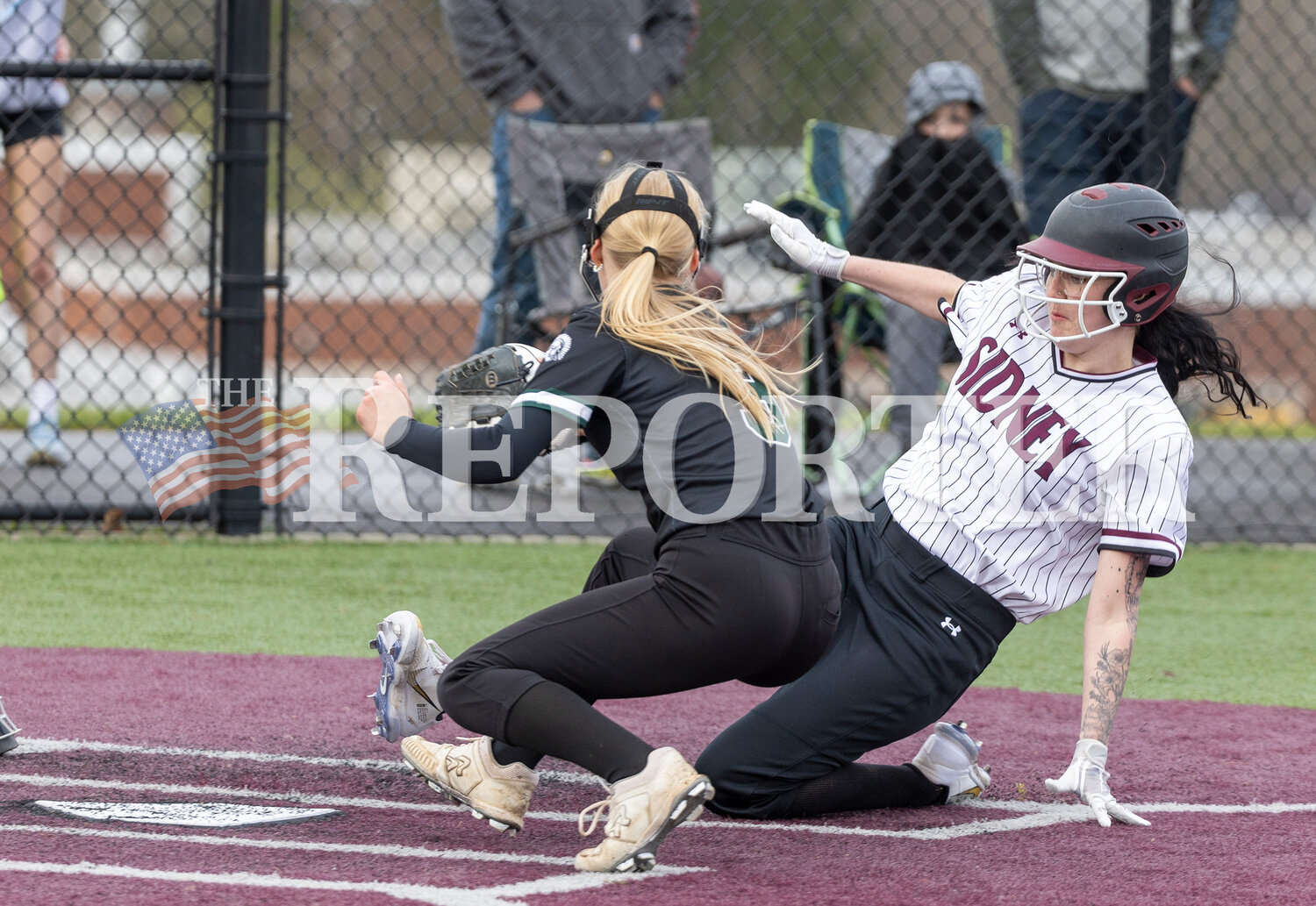 Sidney’s Sammy Constable slides home to score a run as Unatego’s Bailey McCoy defends during her team’s 14-6 win over Unatego Friday, April 12.